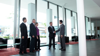 Employee and customer shaking hands in the lobby